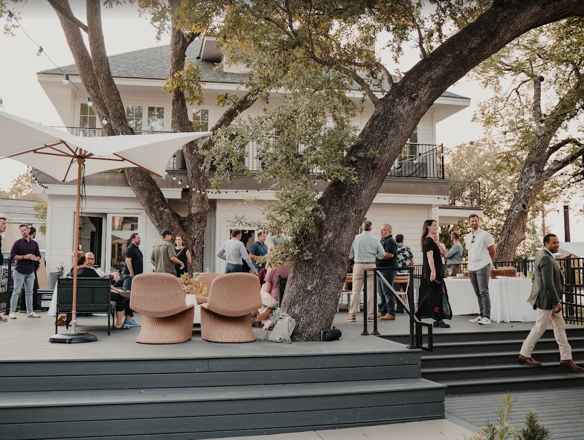 An evening event on the deck beneath the oaks